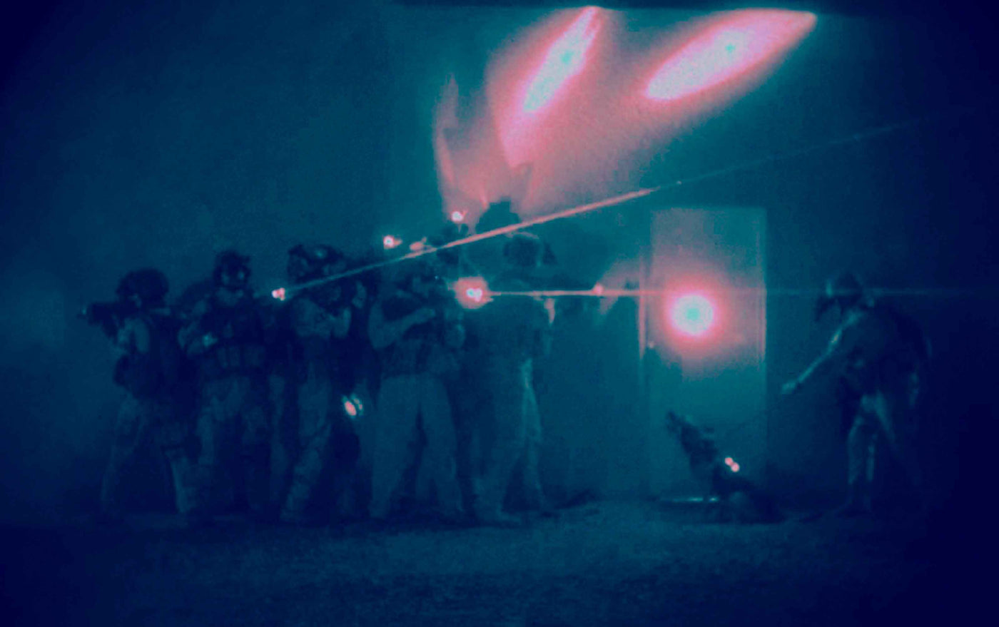 swat team at night making tactical entry on building