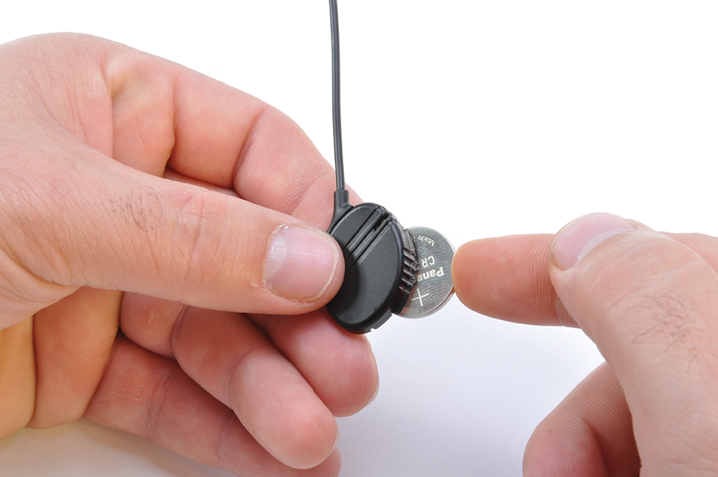 button cell battery being installed into body wire