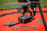 Drone with a camera on an orange surface