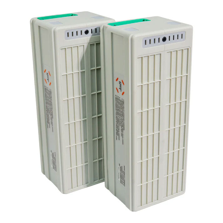 a pair of white drone batteries standing on end