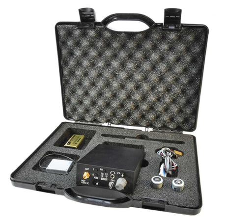 An open black hard carrying case with body wire system, foam interior, containing an electronic device and several attached cables and accessories on a white background.