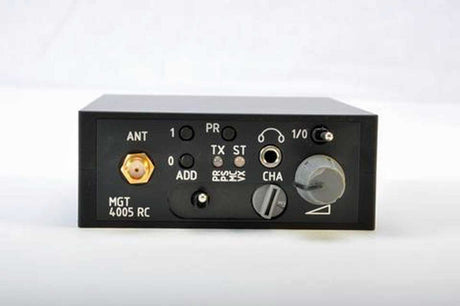 A black police body wire receiver module  with various audio and signal input/output connectors, switches, and a large rotary knob on a white background.