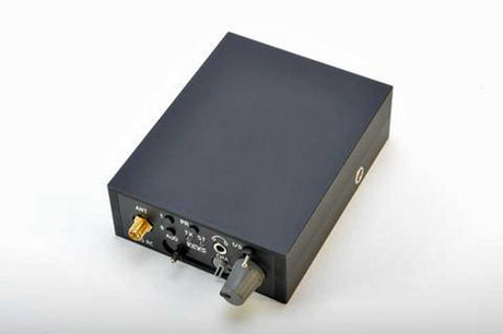 A black body wire with various audio or signal input/output connectors on its side, photographed on a plain white background.