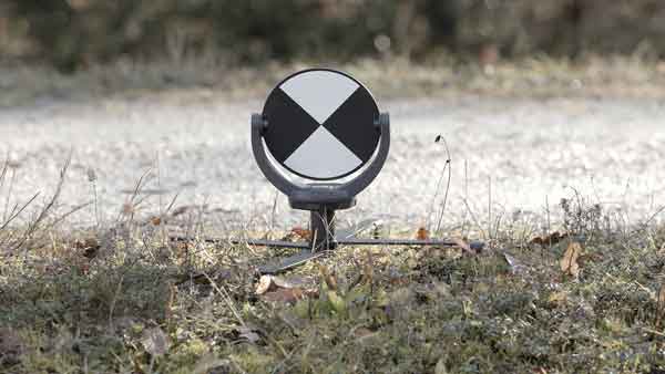 Lidar target on swivel mount next to a gravel road